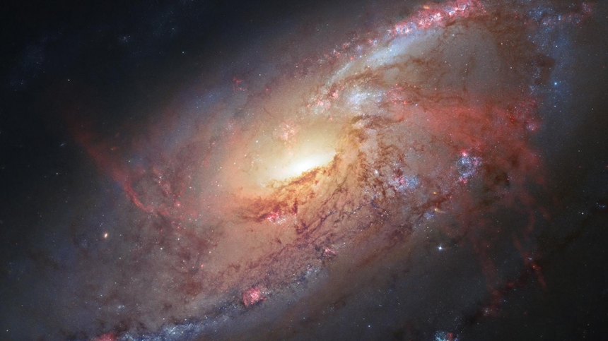 Large amounts of gas from this galaxy (M106) are thought to be falling into a supermassive black hole at its centre / NASA,ESA,Hubble